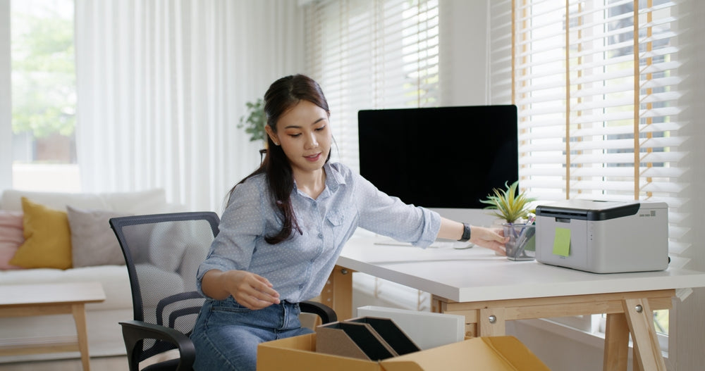 Woman organising her home office desk setup