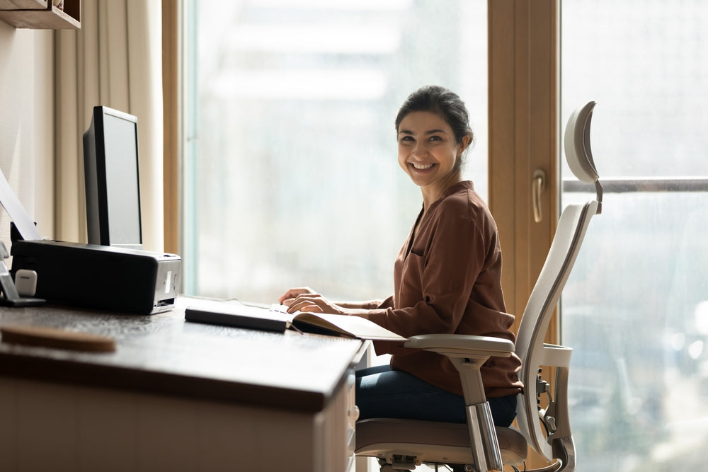 Woman sitting ergonomically at a desk
