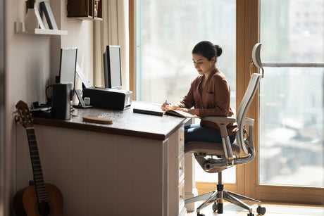 Woman working at her ergonomic Desk Setup