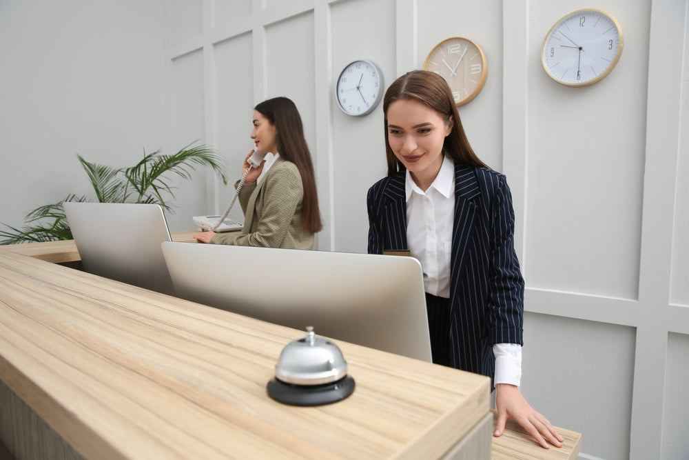 Two women working at reception desk 