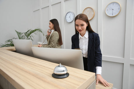 Two women working at reception desk 